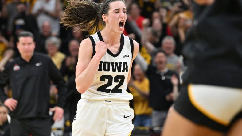 Mar 3, 2024; Iowa City, Iowa, USA; Iowa Hawkeyes guard Caitlin Clark (22) reacts after breaking the NCAA basketball all-time scoring record during the second quarter against the Ohio State Buckeyes. Mandatory Credit: Jeffrey Becker-USA TODAY Sports