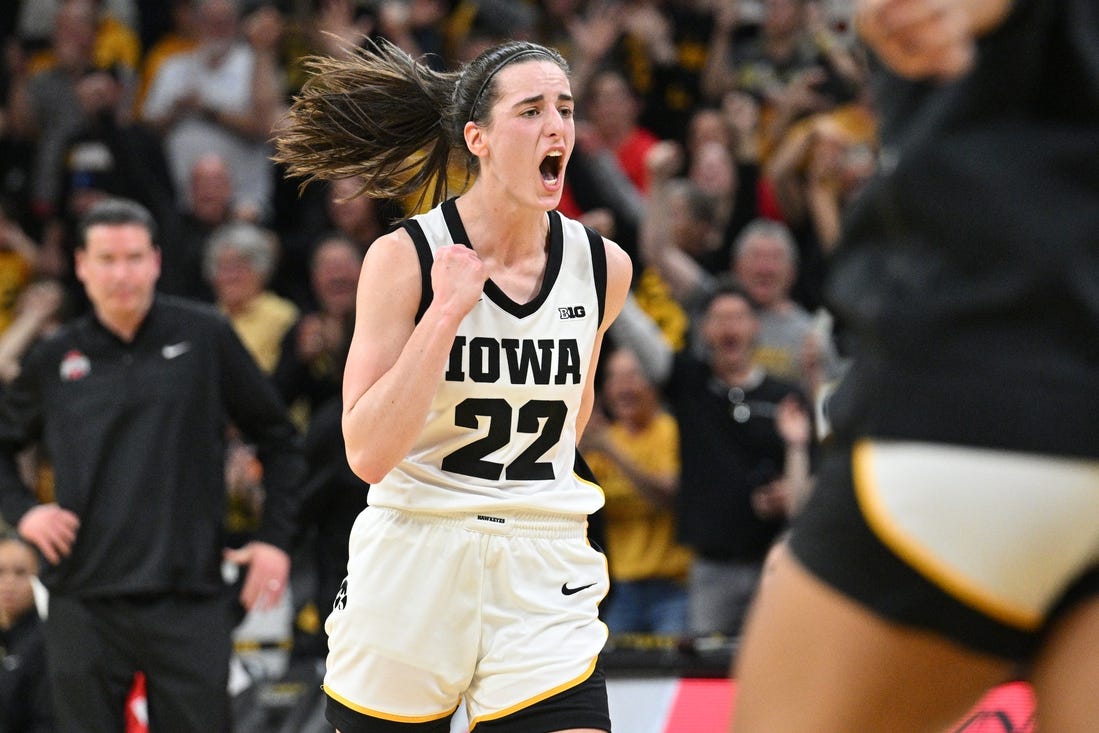 Mar 3, 2024; Iowa City, Iowa, USA; Iowa Hawkeyes guard Caitlin Clark (22) reacts after breaking the NCAA basketball all-time scoring record during the second quarter against the Ohio State Buckeyes. Mandatory Credit: Jeffrey Becker-USA TODAY Sports