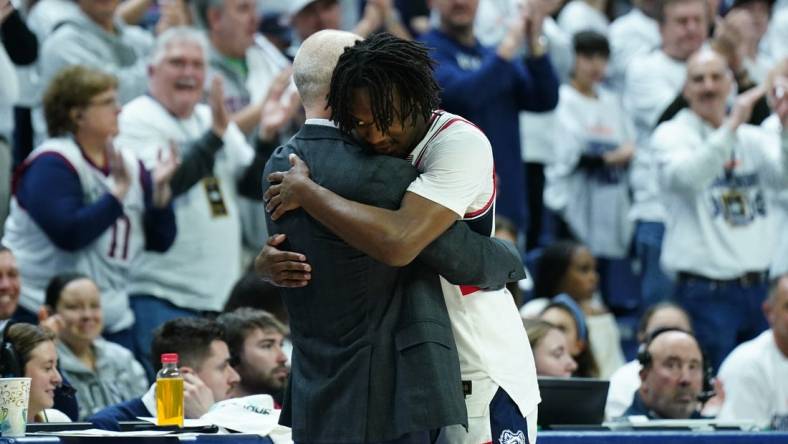 Mar 3, 2024; Storrs, Connecticut, USA; UConn Huskies head coach Dan Hurley hugs guard Tristen Newton (2) as he comes off the court during his final home game as they take on the Seton Hall Pirates at Harry A. Gampel Pavilion. Mandatory Credit: David Butler II-USA TODAY Sports