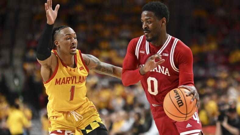 Mar 3, 2024; College Park, Maryland, USA;  Indiana Hoosiers guard Xavier Johnson (0) drives to the basket on Maryland Terrapins guard Jahmir Young (1) during the first half at Xfinity Center. Mandatory Credit: Tommy Gilligan-USA TODAY Sports