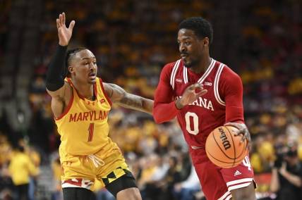 Mar 3, 2024; College Park, Maryland, USA;  Indiana Hoosiers guard Xavier Johnson (0) drives to the basket on Maryland Terrapins guard Jahmir Young (1) during the first half at Xfinity Center. Mandatory Credit: Tommy Gilligan-USA TODAY Sports
