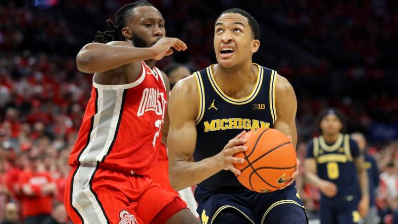 Mar 3, 2024; Columbus, Ohio, USA; Michigan Wolverines guard Nimari Burnett (4) drives to the basket as Ohio State Buckeyes guard Bruce Thornton (2) defends during the first half at Value City Arena. Mandatory Credit: Joseph Maiorana-USA TODAY Sports