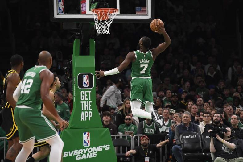 Mar 3, 2024; Boston, Massachusetts, USA;  Boston Celtics guard Jaylen Brown (7) goes in for a dunk during the second half against the Golden State Warriors at TD Garden. Mandatory Credit: Bob DeChiara-USA TODAY Sports