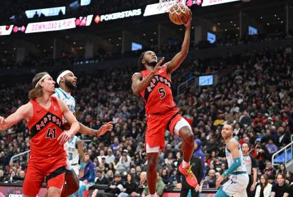 Mar 3, 2024; Toronto, Ontario, CAN;  Toronto Raptors guard Immanuel Quickley (5) scores on a layup against the Charlotte Hornets in the first half at Scotiabank Arena. Mandatory Credit: Dan Hamilton-USA TODAY Sports