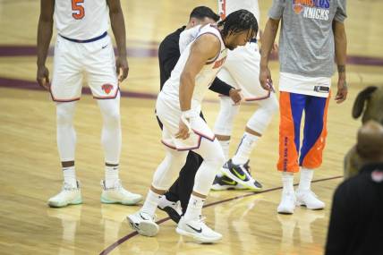Mar 3, 2024; Cleveland, Ohio, USA; New York Knicks guard Jalen Brunson (11) limps off the court in the first quarter against the Cleveland Cavaliers at Rocket Mortgage FieldHouse. Mandatory Credit: David Richard-USA TODAY Sports
