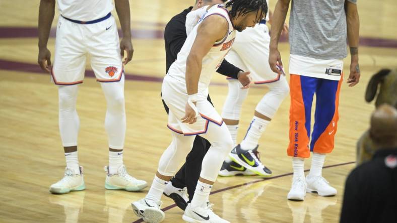 Mar 3, 2024; Cleveland, Ohio, USA; New York Knicks guard Jalen Brunson (11) limps off the court in the first quarter against the Cleveland Cavaliers at Rocket Mortgage FieldHouse. Mandatory Credit: David Richard-USA TODAY Sports