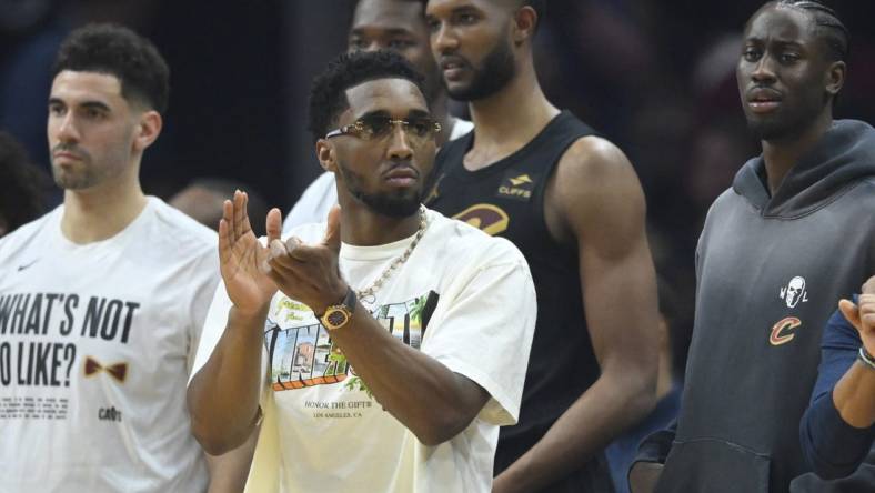 Mar 3, 2024; Cleveland, Ohio, USA; Cleveland Cavaliers guard Donovan Mitchell (front) reacts in the second quarter against the New York Knicks at Rocket Mortgage FieldHouse. Mandatory Credit: David Richard-USA TODAY Sports