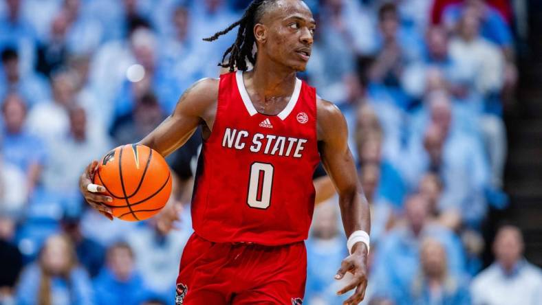 Mar 2, 2024; Chapel Hill, North Carolina, USA; North Carolina State Wolfpack guard DJ Horne (0) brings the ball up court against the North Carolina Tar Heels at Dean E. Smith Center. Mandatory Credit: Scott Kinser-USA TODAY Sports