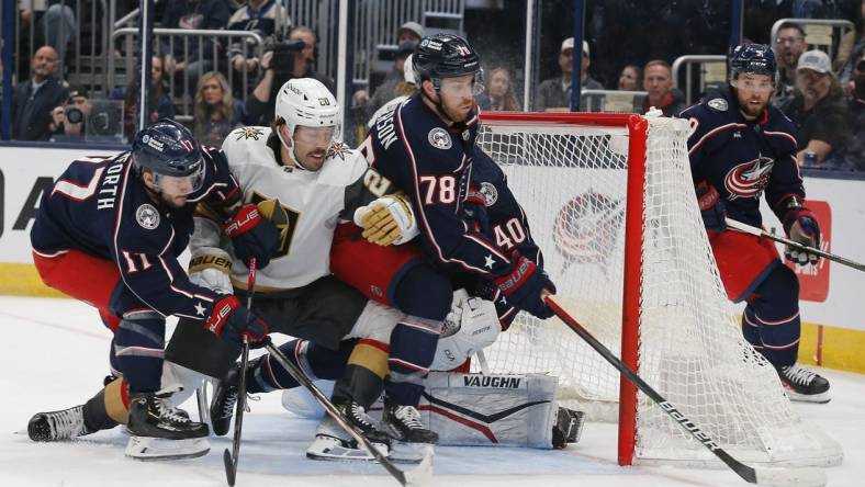 Mar 4, 2024; Columbus, Ohio, USA; Columbus Blue Jackets defenseman Damon Severson (78) clears a loose puck against the Vegas Golden Knights during the first period at Nationwide Arena. Mandatory Credit: Russell LaBounty-USA TODAY Sports