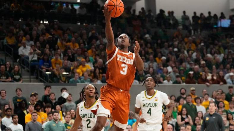 Mar 4, 2024; Waco, Texas, USA;  Texas Longhorns guard Max Abmas (3) scores a layup past Baylor Bears guard Jayden Nunn (2) during the first half at Paul and Alejandra Foster Pavilion. Mandatory Credit: Chris Jones-USA TODAY Sports