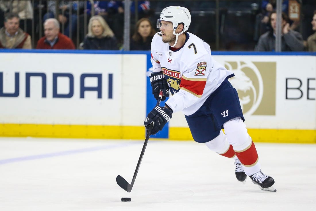 Mar 4, 2024; New York, New York, USA;  Florida Panthers defenseman Dmitry Kulikov (7) controls the puck in the first period against the New York Rangers at Madison Square Garden. Mandatory Credit: Wendell Cruz-USA TODAY Sports