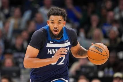 Mar 4, 2024; Minneapolis, Minnesota, USA; Minnesota Timberwolves center Karl-Anthony Towns (32) dribbles against the Portland Trail Blazers in the third quarter at Target Center. Mandatory Credit: Brad Rempel-USA TODAY Sports