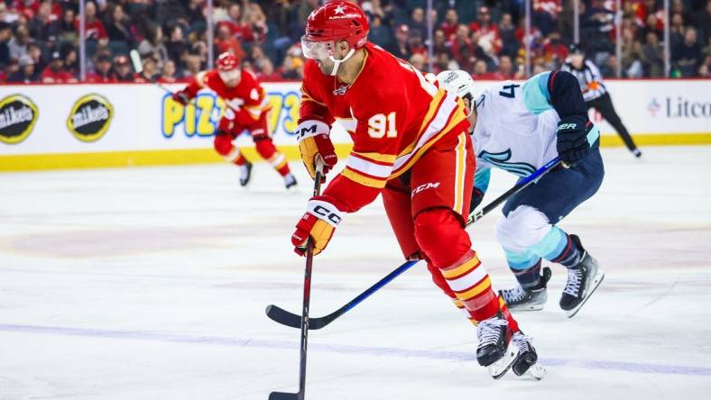 Mar 4, 2024; Calgary, Alberta, CAN; Calgary Flames center Nazem Kadri (91) controls the puck against the Seattle Kraken during the second period at Scotiabank Saddledome. Mandatory Credit: Sergei Belski-USA TODAY Sports