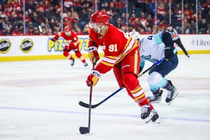 Mar 4, 2024; Calgary, Alberta, CAN; Calgary Flames center Nazem Kadri (91) controls the puck against the Seattle Kraken during the second period at Scotiabank Saddledome. Mandatory Credit: Sergei Belski-USA TODAY Sports