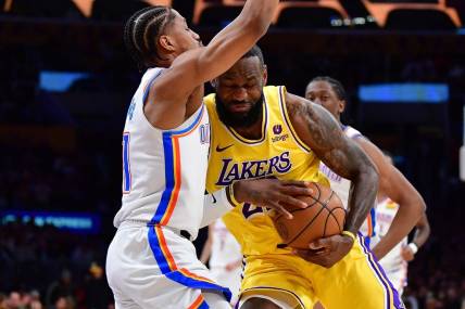 Mar 4, 2024; Los Angeles, California, USA; Los Angeles Lakers forward LeBron James (23) moves to the basket against Oklahoma City Thunder guard Aaron Wiggins (21) during the first half at Crypto.com Arena. Mandatory Credit: Gary A. Vasquez-USA TODAY Sports