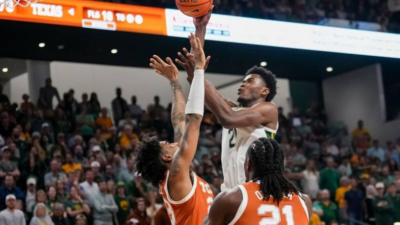 Mar 4, 2024; Waco, Texas, USA;  Baylor Bears center Yves Missi (21) scores a basket over Texas Longhorns forward Dillon Mitchell (23) during the second half at Paul and Alejandra Foster Pavilion. Mandatory Credit: Chris Jones-USA TODAY Sports