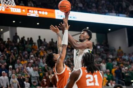 Mar 4, 2024; Waco, Texas, USA;  Baylor Bears center Yves Missi (21) scores a basket over Texas Longhorns forward Dillon Mitchell (23) during the second half at Paul and Alejandra Foster Pavilion. Mandatory Credit: Chris Jones-USA TODAY Sports