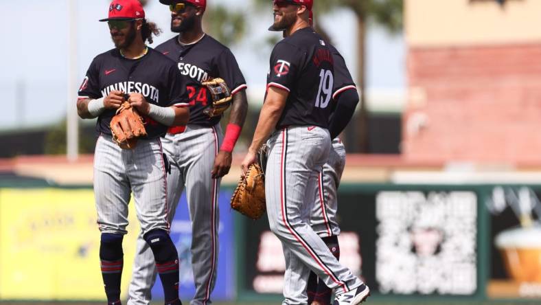 Mar 5, 2024; Jupiter, Florida, USA; Minnesota Twins second baseman Austin Martin (82), third baseman Niko Goodrum (24) and first baseman Alex Kirilloff (19) look on against the St. Louis Cardinals during the third inning at Roger Dean Chevrolet Stadium. Mandatory Credit: Sam Navarro-USA TODAY Sports