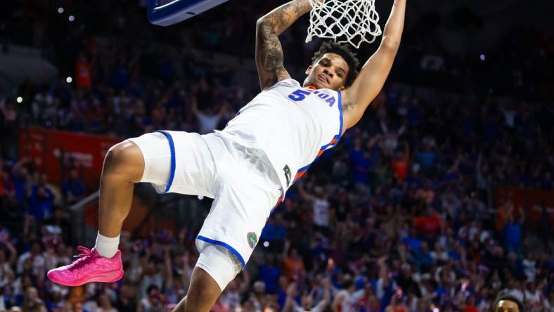 Florida Gators guard Will Richard (5) dunks the ball during the first half. The Florida men   s basketball team hosted the Alabama Crimson Tied at Exactech Arena at the Stephen C. O   Connell Center in Gainesville, FL on Tuesday, March 5, 2024. [Doug Engle/Ocala Star Banner]