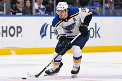 Mar 5, 2024; Elmont, New York, USA; St. Louis Blues center Robert Thomas (18) skates with puck against the New York Islanders during the first period at UBS Arena. Mandatory Credit: Dennis Schneidler-USA TODAY Sports