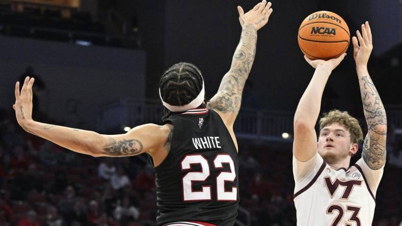 Mar 5, 2024; Louisville, Kentucky, USA; Virginia Tech Hokies guard Tyler Nickel (23) shoots against Louisville Cardinals guard Tre White (22) during the first half at KFC Yum! Center. Mandatory Credit: Jamie Rhodes-USA TODAY Sports