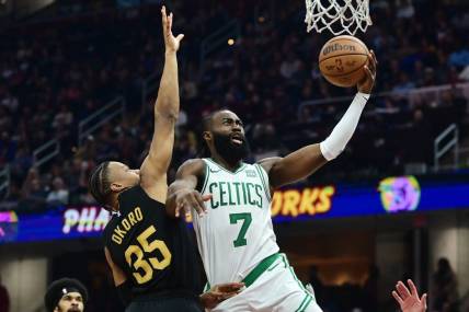 Mar 5, 2024; Cleveland, Ohio, USA;  Boston Celtics guard Jaylen Brown (7) drives to the basket against Cleveland Cavaliers forward Isaac Okoro (35) during the first half at Rocket Mortgage FieldHouse. Mandatory Credit: Ken Blaze-USA TODAY Sports
