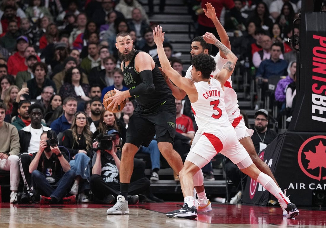 Mar 5, 2024; Toronto, Ontario, CAN; New Orleans Pelicans center Jonas Valanciunas (17) controls the ball as Toronto Raptors guard D.J. Carton (3) tries to defend during the second quarter at Scotiabank Arena. Mandatory Credit: Nick Turchiaro-USA TODAY Sports