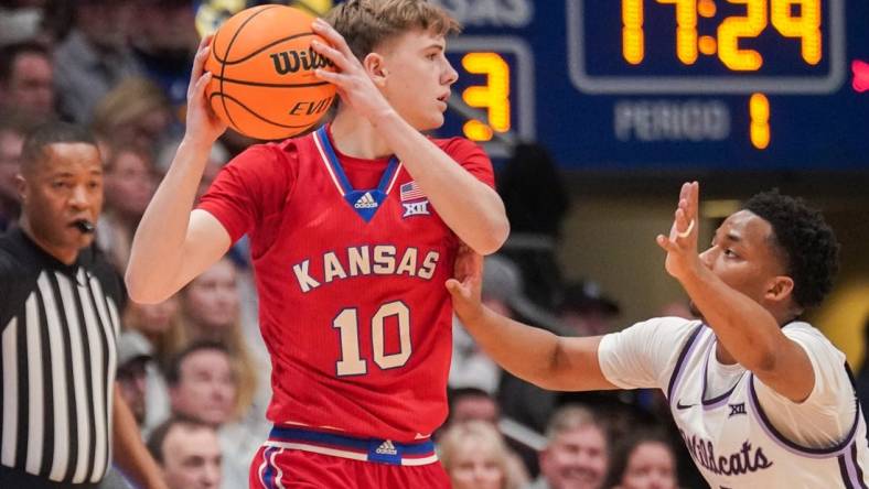 Mar 5, 2024; Lawrence, Kansas, USA; Kansas Jayhawks guard Johnny Furphy (10) looks to pass as Kansas State Wildcats guard Tylor Perry (2) defends during the first half at Allen Fieldhouse. Mandatory Credit: Denny Medley-USA TODAY Sports