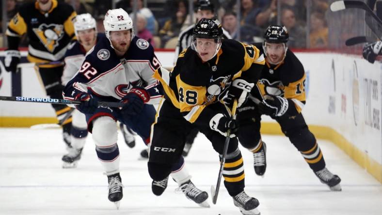 Mar 5, 2024; Pittsburgh, Pennsylvania, USA; Pittsburgh Penguins right wing Valtteri Puustinen (48) skates with the puck against the Columbus Blue Jackets during the third period at PPG Paints Arena. The Penguins won 5-3. Mandatory Credit: Charles LeClaire-USA TODAY Sports