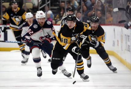 Mar 5, 2024; Pittsburgh, Pennsylvania, USA; Pittsburgh Penguins right wing Valtteri Puustinen (48) skates with the puck against the Columbus Blue Jackets during the third period at PPG Paints Arena. The Penguins won 5-3. Mandatory Credit: Charles LeClaire-USA TODAY Sports