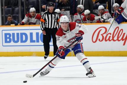 Mar 5, 2024; Nashville, Tennessee, USA; Montreal Canadiens right wing Cole Caufield (22) passes the puck during the second period against the Nashville Predators at Bridgestone Arena. Mandatory Credit: Christopher Hanewinckel-USA TODAY Sports