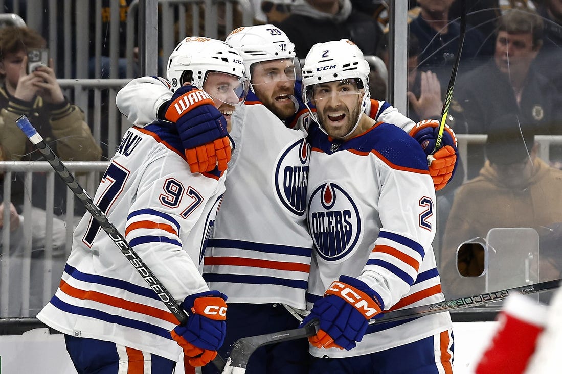 Mar 5, 2024; Boston, Massachusetts, USA; Edmonton Oilers center Leon Draisaitl (29) celebrates his game winning overtime goal against the Boston Bruins with teammates center Connor McDavid (97) and defenseman Evan Bouchard (2) at TD Garden. Mandatory Credit: Winslow Townson-USA TODAY Sports