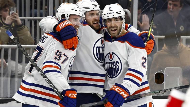 Mar 5, 2024; Boston, Massachusetts, USA; Edmonton Oilers center Leon Draisaitl (29) celebrates his game winning overtime goal against the Boston Bruins with teammates center Connor McDavid (97) and defenseman Evan Bouchard (2) at TD Garden. Mandatory Credit: Winslow Townson-USA TODAY Sports