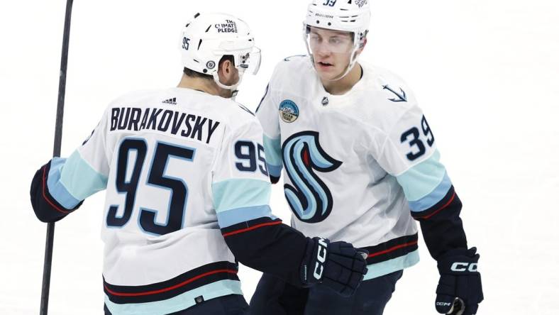 Mar 5, 2024; Winnipeg, Manitoba, CAN; Seattle Kraken left wing Andre Burakovsky (95) celebrates his third period goal with  Seattle Kraken defenseman Ryker Evans (39) against the Winnipeg Jets at Canada Life Centre. Mandatory Credit: James Carey Lauder-USA TODAY Sports