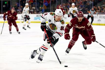 Mar 5, 2024; Tempe, Arizona, USA;  Chicago Blackhawks left wing Anthony Beauvillier (91) moves the puck against Arizona Coyotes defenseman Sean Durzi (50) during the third period at Mullett Arena. Mandatory Credit: Mark J. Rebilas-USA TODAY Sports