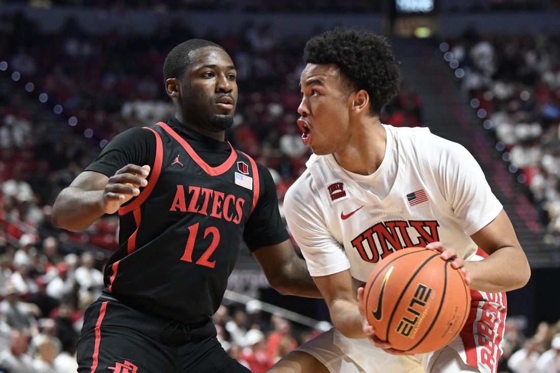 Mar 5, 2024; Las Vegas, Nevada, USA; San Diego State Aztecs guard Darrion Trammell (12) defends against UNLV Rebels guard Dedan Thomas Jr. (11) in the first half at Thomas & Mack Center. Mandatory Credit: Candice Ward-USA TODAY Sports