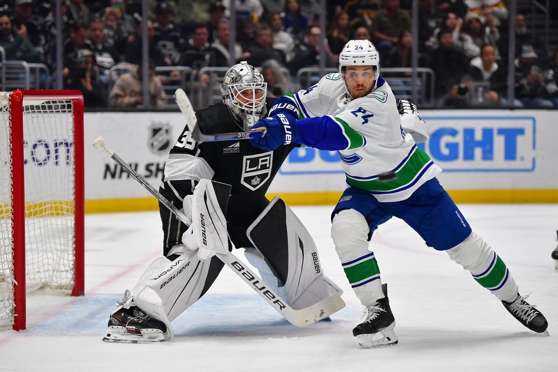 Mar 5, 2024; Los Angeles, California, USA; Vancouver Canucks center Pius Suter (24) moves in for the puck against Los Angeles Kings goaltender Cam Talbot (39) during the third period at Crypto.com Arena. Mandatory Credit: Gary A. Vasquez-USA TODAY Sports