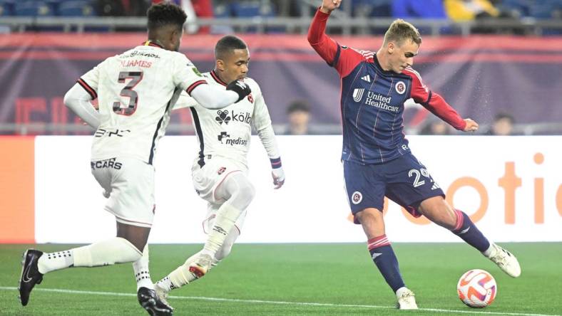 Mar 6, 2024; Foxborough, MA, USA; New England Revolution midfielder Noel Buck (29) takes a shot against Liga Deportiva Alajuelense during the second half of a match at Gillette Stadium. Mandatory Credit: Brian Fluharty-USA TODAY Sports