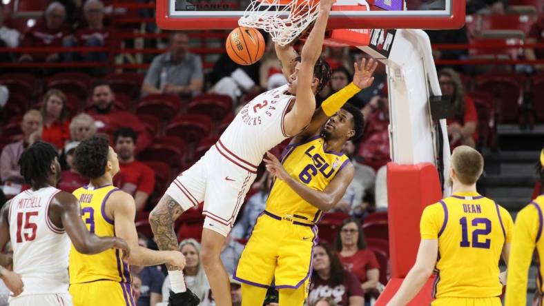 Mar 6, 2024; Fayetteville, Arkansas, USA; Arkansas Razorbacks forward Trevon Brazile (2) dunks the ball in the first half as LSU Tigers guard Jordan Wright (6) defends at Bud Walton Arena. Mandatory Credit: Nelson Chenault-USA TODAY Sports