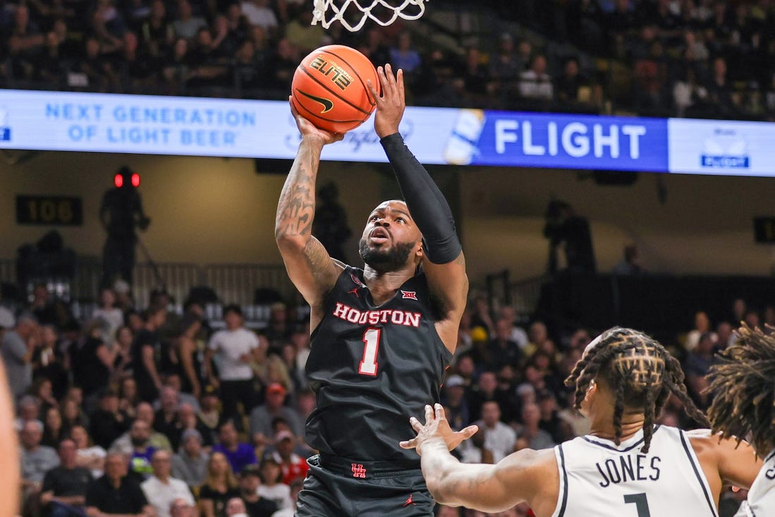 Mar 6, 2024; Orlando, Florida, USA; Houston Cougars guard Jamal Shead (1) goes to the basket in front of UCF Knights guard Antwann Jones (1) during the first half at Addition Financial Arena. Mandatory Credit: Mike Watters-USA TODAY Sports