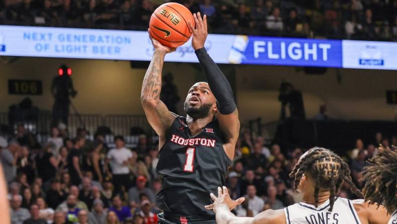 Mar 6, 2024; Orlando, Florida, USA; Houston Cougars guard Jamal Shead (1) goes to the basket in front of UCF Knights guard Antwann Jones (1) during the first half at Addition Financial Arena. Mandatory Credit: Mike Watters-USA TODAY Sports