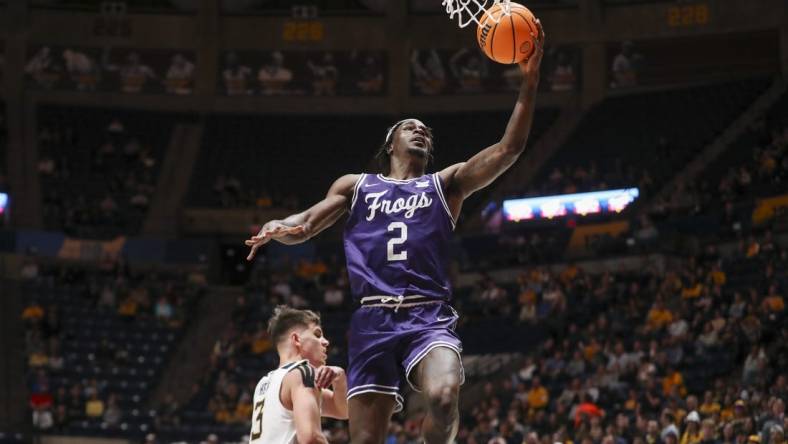 Mar 6, 2024; Morgantown, West Virginia, USA; TCU Horned Frogs forward Emanuel Miller (2) shoots in the lane during the first half against the West Virginia Mountaineers at WVU Coliseum. Mandatory Credit: Ben Queen-USA TODAY Sports