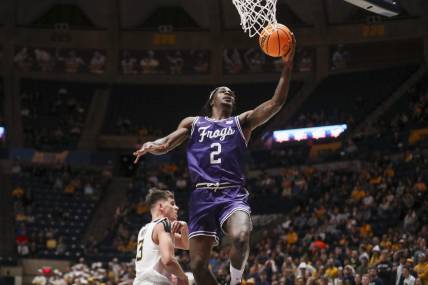 Mar 6, 2024; Morgantown, West Virginia, USA; TCU Horned Frogs forward Emanuel Miller (2) shoots in the lane during the first half against the West Virginia Mountaineers at WVU Coliseum. Mandatory Credit: Ben Queen-USA TODAY Sports