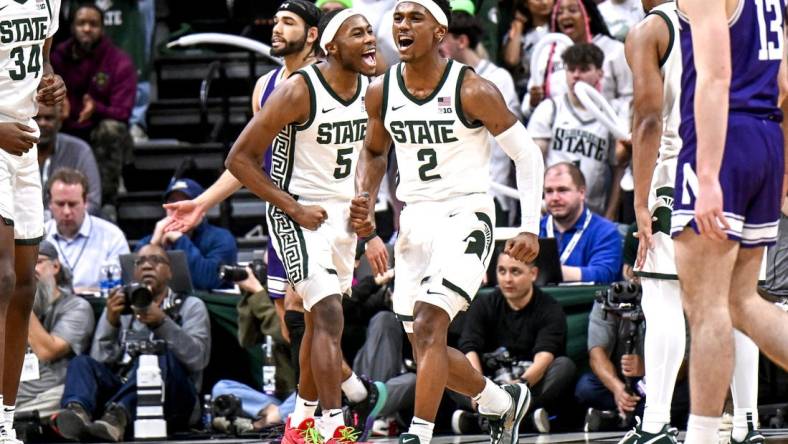 Michigan State's Tyson Walker, right, and Tre Holloman celebrate a Northwestern turnover during the second half on Wednesday, March 6, 2024, at the Breslin Center in East Lansing.