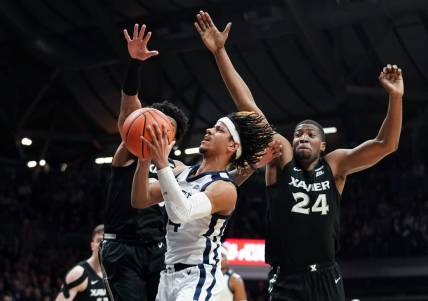 Mar 6, 2024; Indianapolis, Indiana, USA;  Butler Bulldogs guard DJ Davis (4) goes to the basket against Xavier Musketeers guard Dayvion McKnight (20) and Xavier Musketeers forward Abou Ousmane (24) during the first half at Hinkle Fieldhouse. Mandatory Credit: Robert Goddin-USA TODAY Sports