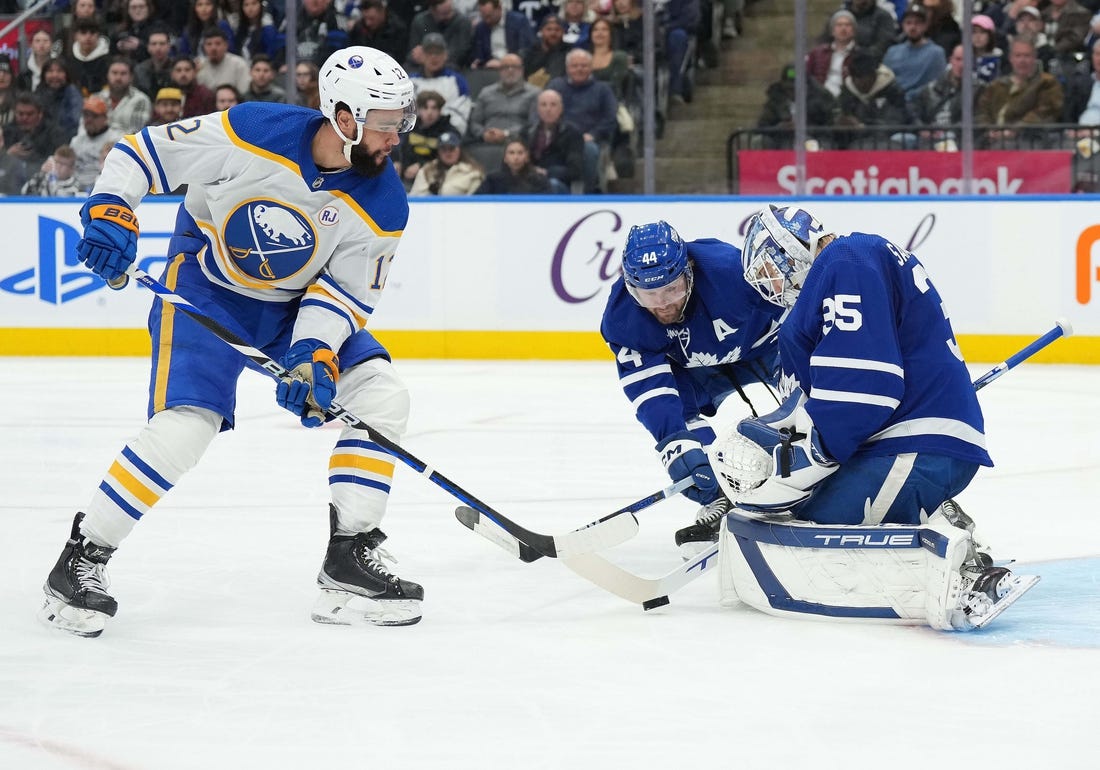 Mar 6, 2024; Toronto, Ontario, CAN; Toronto Maple Leafs defenseman Morgan Rielly (44) battles for the puck with Buffalo Sabres left wing Jordan Greenway (12) in front of goaltender Ilya Samsonov (35) during the second period at Scotiabank Arena. Mandatory Credit: Nick Turchiaro-USA TODAY Sports