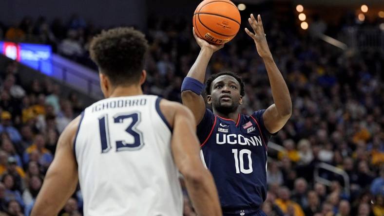 Mar 6, 2024; Milwaukee, Wisconsin, USA;  Connecticut Huskies guard Hassan Diarra (10) shoots during the first half against the Marquette Golden Eagles at Fiserv Forum. Mandatory Credit: Jeff Hanisch-USA TODAY Sports