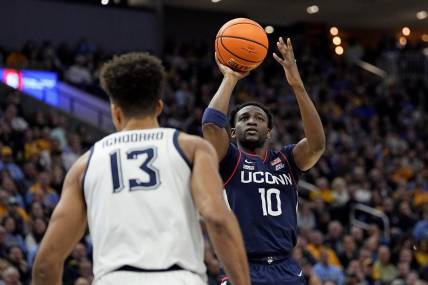 Mar 6, 2024; Milwaukee, Wisconsin, USA;  Connecticut Huskies guard Hassan Diarra (10) shoots during the first half against the Marquette Golden Eagles at Fiserv Forum. Mandatory Credit: Jeff Hanisch-USA TODAY Sports