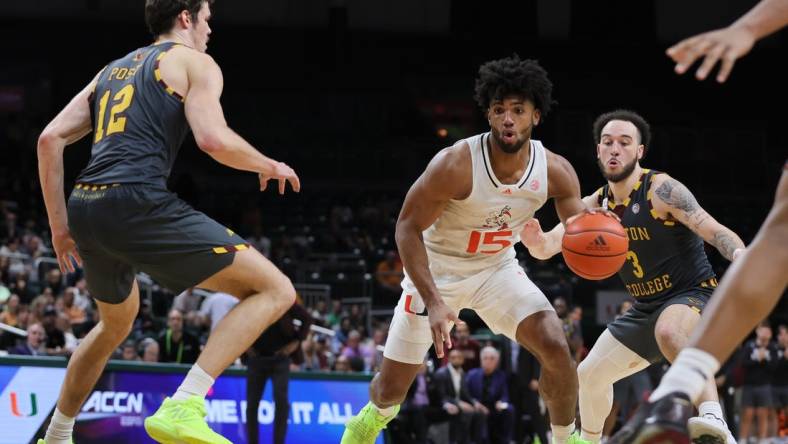 Mar 6, 2024; Coral Gables, Florida, USA; Miami Hurricanes forward Norchad Omier (15) drives to the basket past Boston College Eagles guard Jaeden Zackery (3) during the second half at Watsco Center. Mandatory Credit: Sam Navarro-USA TODAY Sports