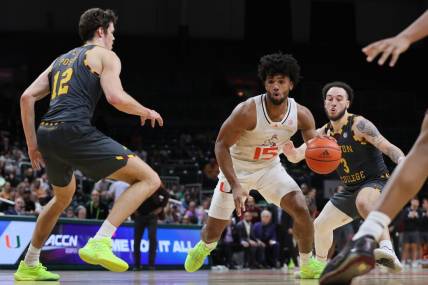 Mar 6, 2024; Coral Gables, Florida, USA; Miami Hurricanes forward Norchad Omier (15) drives to the basket past Boston College Eagles guard Jaeden Zackery (3) during the second half at Watsco Center. Mandatory Credit: Sam Navarro-USA TODAY Sports